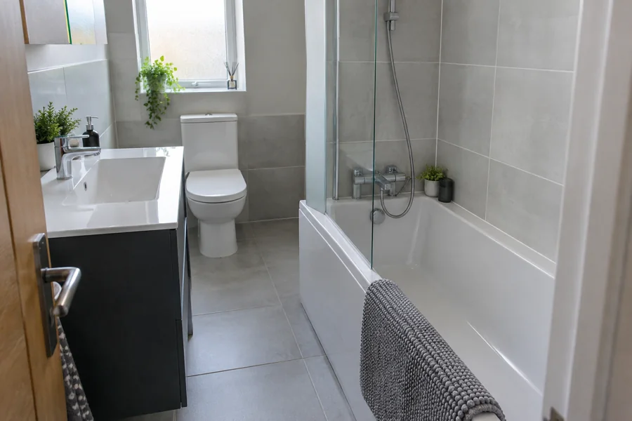 Drawer vanity clear of the bathroom doorway beside a fitted bath